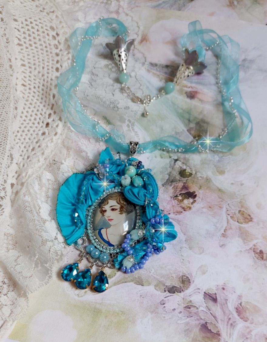 Pendentif Mademoiselle au style rétro avec cabochon d’une femme souriante, orné d’un ruban de soie Bleu, cristaux, perles verre : rocailles et roses, coupelles et chaîne Argent 925/1000