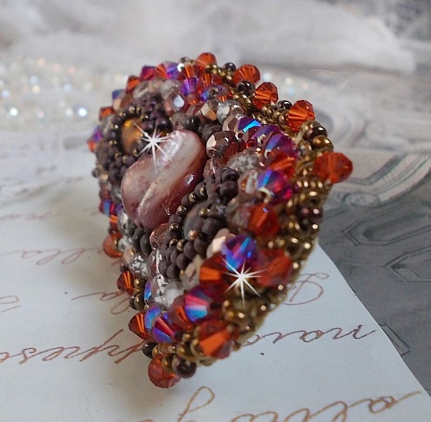 Topaz hair clip embroidered with a mahogany mother-of-pearl cabochon, Swarovski crystals and seed beads