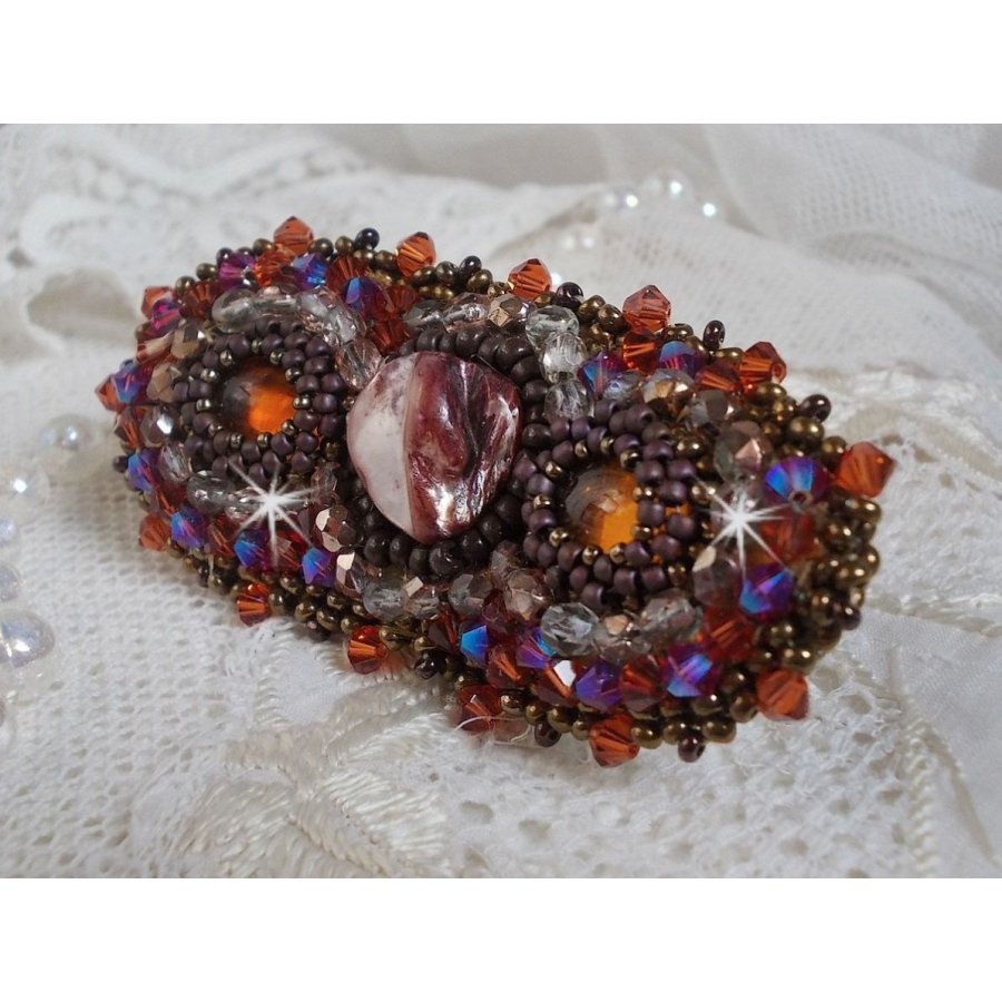 Topaz hair clip embroidered with a mahogany mother-of-pearl cabochon, Swarovski crystals and seed beads