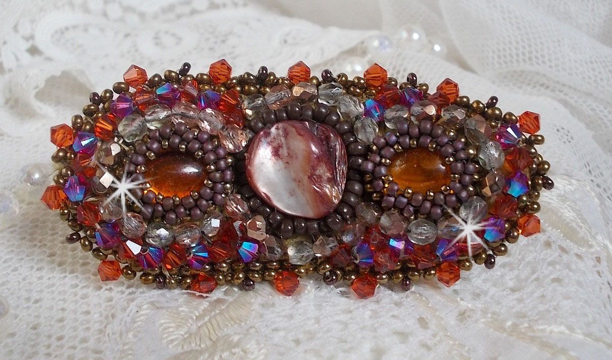 Topaz hair clip embroidered with a mahogany mother-of-pearl cabochon, Swarovski crystals and seed beads