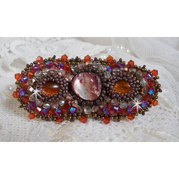 Topaz hair clip embroidered with a mahogany mother-of-pearl cabochon, Swarovski crystals and seed beads