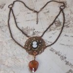 Watson necklace created with prints, a Swarovski crystal pendant with retro look, brass accessories and a resin cabochon