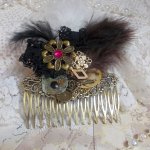 Curiosity Time hair comb created with black lace, various accessories, charms of gold, silver, bronze colors with black, brown and white feathers