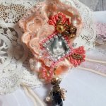 Rustic Rose brooch created with a cabochon representing a smiling girl, rhinestone and pink lace, crystals, glass beads and various accessories