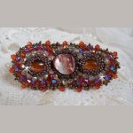 Topaz hair clip embroidered with a mahogany mother-of-pearl cabochon, Swarovski crystals and seed beads