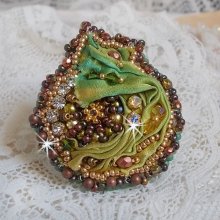 Venetian moon ring embroidered with a chameleon colored silk ribbon, Swarovski crystals, various pearls and seed beads