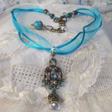 Lady in Blue pendant necklace mounted with Swarovski crystals, flower spacers, foliage cups and ribbons
