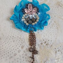 Belle Epoque Haute-Couture brooch is embroidered with Swarovski crystals, round pearls, charms, ribbon and seed beads