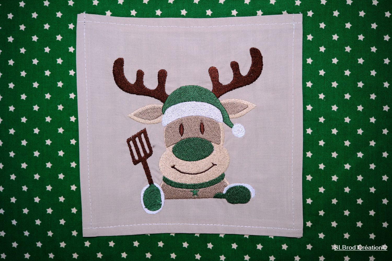 Green reindeer embroidered apron