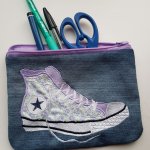 Flat case embroidered with purple sneakers